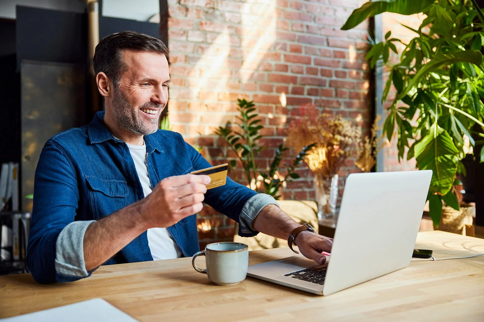 Businessman doing online shopping on laptop with credit card